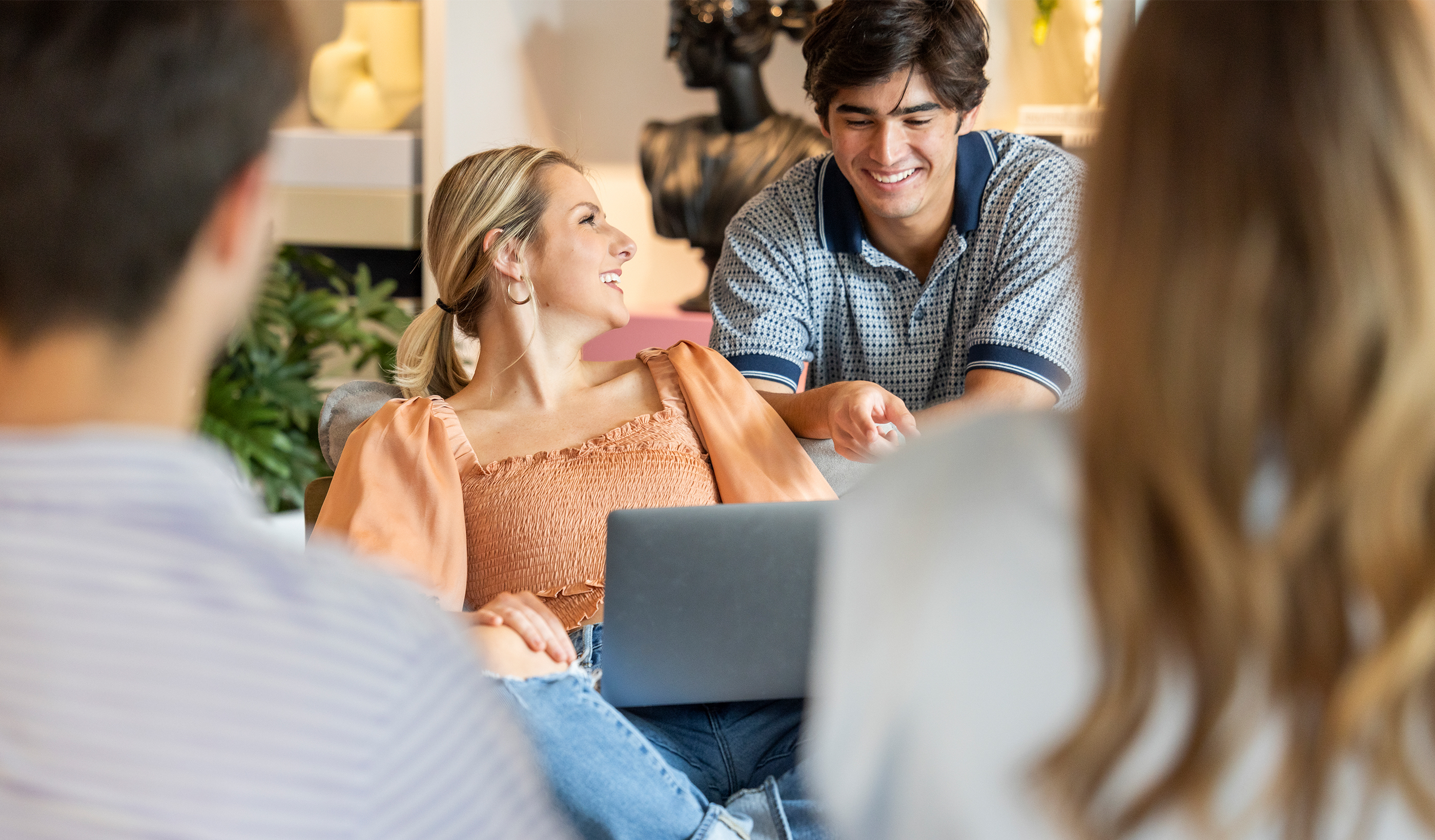 Two people looking at a laptop
