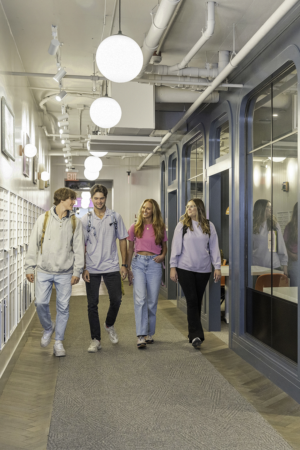 A group of friends walking in a hallway