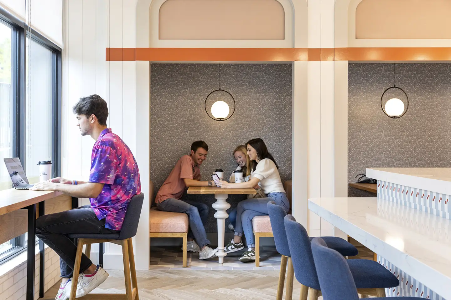 Students sharing a booth in the study spaces at ōLiv Auburn