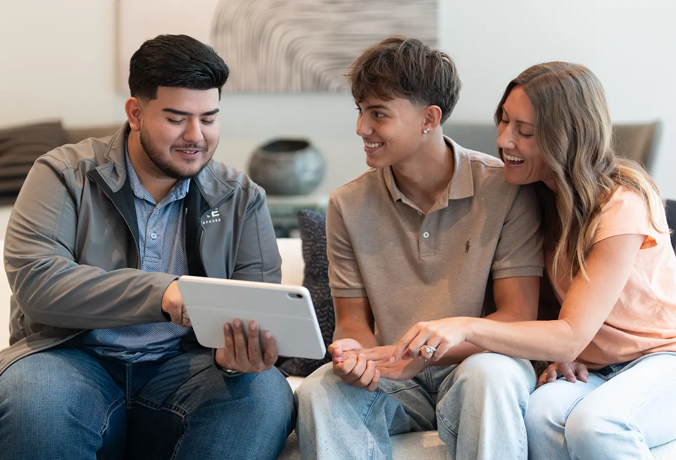 a family crowded around a tablet
